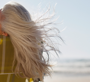 New Research Calls Sunscreen Safety Into Question lady at the beach